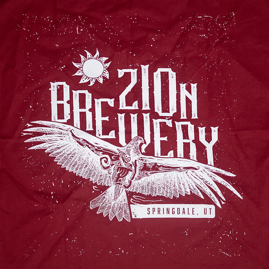 Red bandana with white text and eagle design on a red background